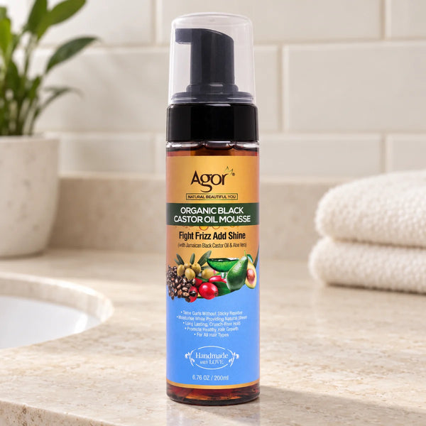 Agor Organic Black Castor Oil Hair Mousse Frizz Control for All Hair Types — 200 ml on a bathroom vanity.