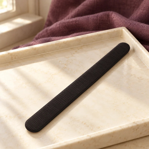 PONY-O Bun Barz Bun Styling Tool — Black on a dressing-table tray.