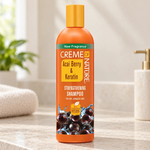 Creme Of Nature Acai Berry & Keratin Strengthening Shampoo — 12 oz on a bathroom vanity or dressing table.