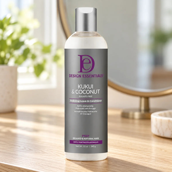 Design Essentials Kukui & Coconut Hydrating Leave-In Conditioner — 12 oz on a bathroom vanity.
