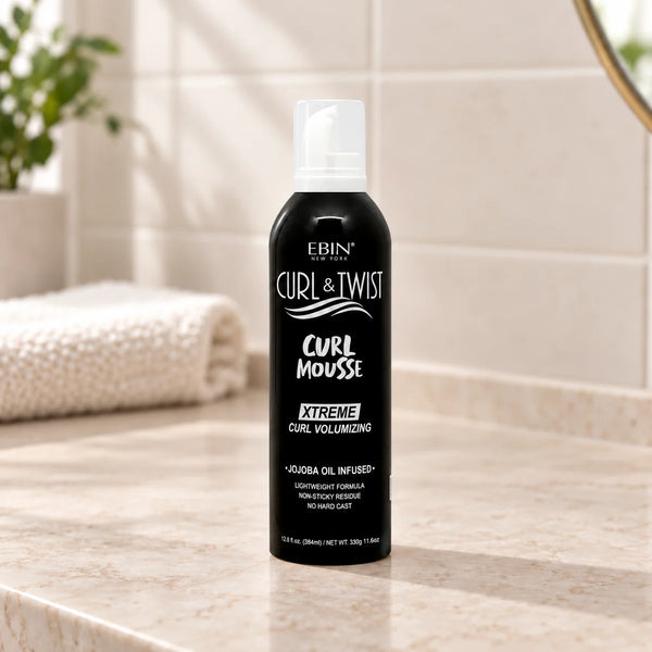 Ebin - Curl & Twist Curl Mousse Xtreme Curl Volumizing Jojoba Oil Infused - on a bathroom vanity.