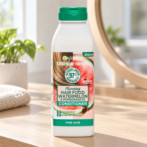 Garnier Hair Food Watermelon & Pomegranate Conditioner: Hydrating & Detangling for Dry, Dull Hair — 350 ml on a bathroom vanity.