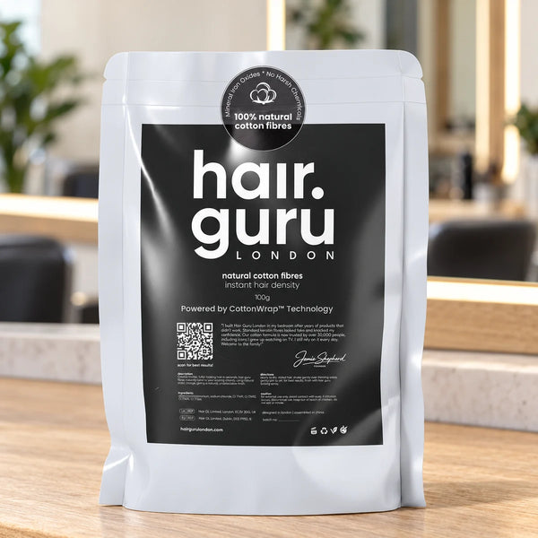 Hair Guru 100g refill pouch on a salon worktop.