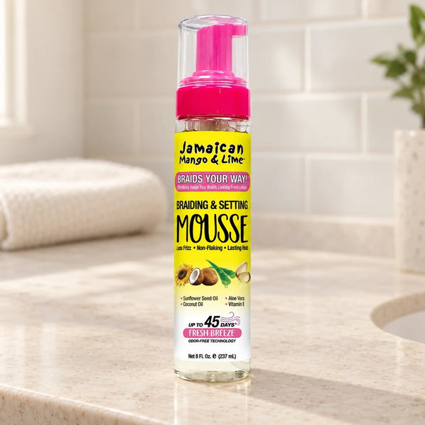 Jamaican Mango & Lime Braiding & Setting Mousse — 8 oz on a bathroom vanity.