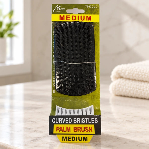 Magic Collection Curved Bristles Medium Palm Brush for Superior Wave Creation & Definition (7703CVD) on a bathroom vanity or dressing table.
