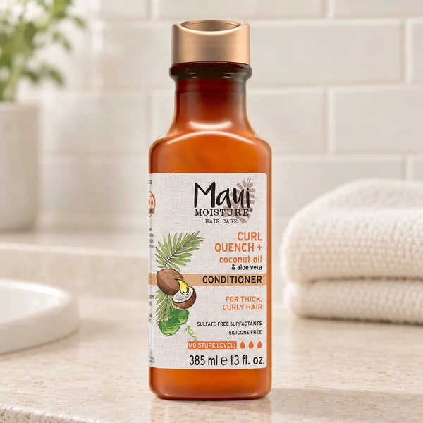 Maui Moisture Curl Quench + Coconut Oil Conditioner — 385 ml on a bathroom vanity.