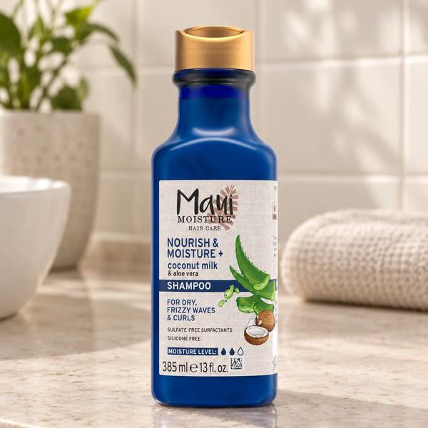 Maui Moisture Nourish & Moisture + Coconut Milk Shampoo — 385 ml on a bathroom vanity.
