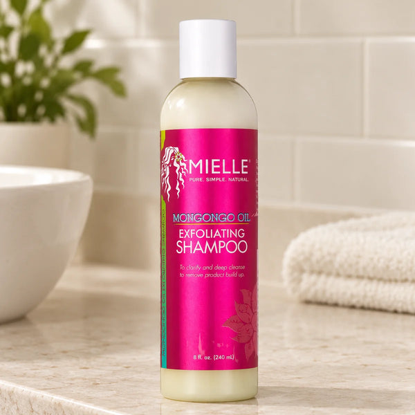 Mielle Mongongo Oil Exfoliating Shampoo — 8 oz on a bathroom vanity.