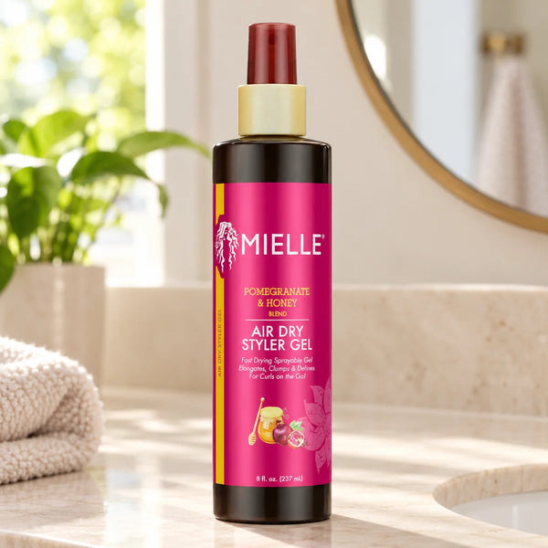 Mielle Pomegranate & Honey Air Dry Styler Gel — 8 oz on a bathroom vanity.