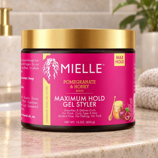 Mielle Pomegranate & Honey Maximum Hold Gel Styler — 16 oz on a bathroom vanity.