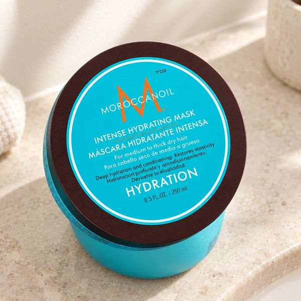 Moroccanoil Intense Hydrating Mask Deeply Hydrating for Dry, Medium to Thick Hair — 250 ml on a bathroom vanity or dressing table.