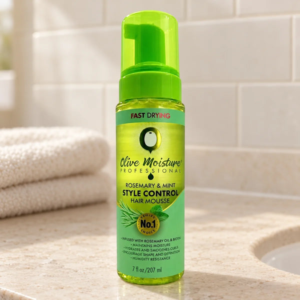 Olive Moisture Rosemary & Mint Style Control Hair Mousse Defines Curls, Boosts Volume & Frizz Control for All Hair Types — 207 ml on a bathroom vanity.