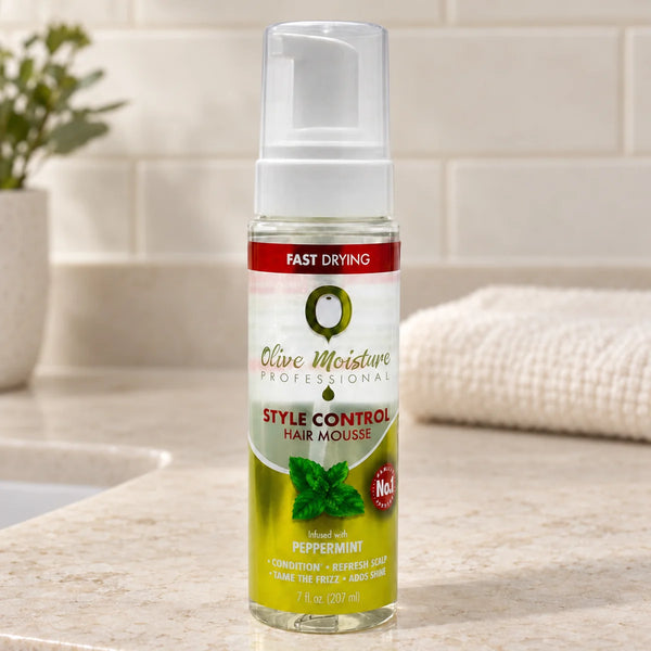 Olive Moisture Style Control Hair Mousse Strong Hold & Frizz Control for All Hair Types — 7 oz on a bathroom vanity.