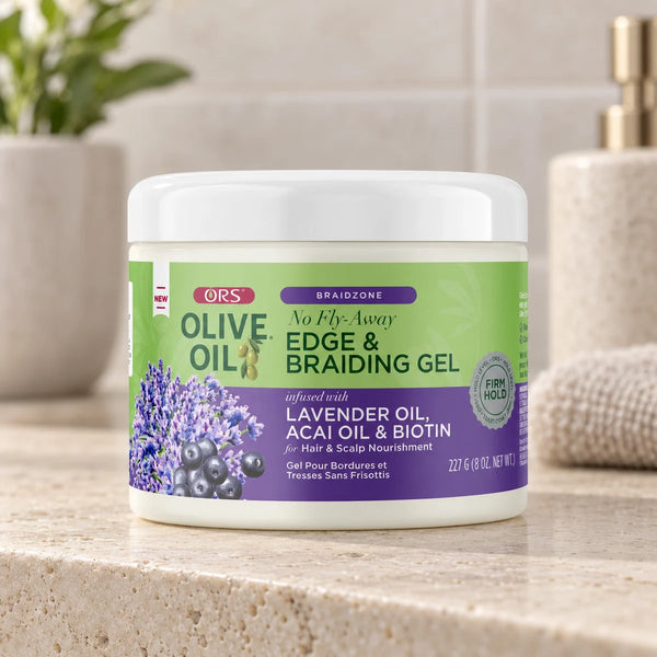 ORS Olive Oil Braidzone No Fly-Away Edge & Braiding Gel — 227 g on a bathroom vanity.