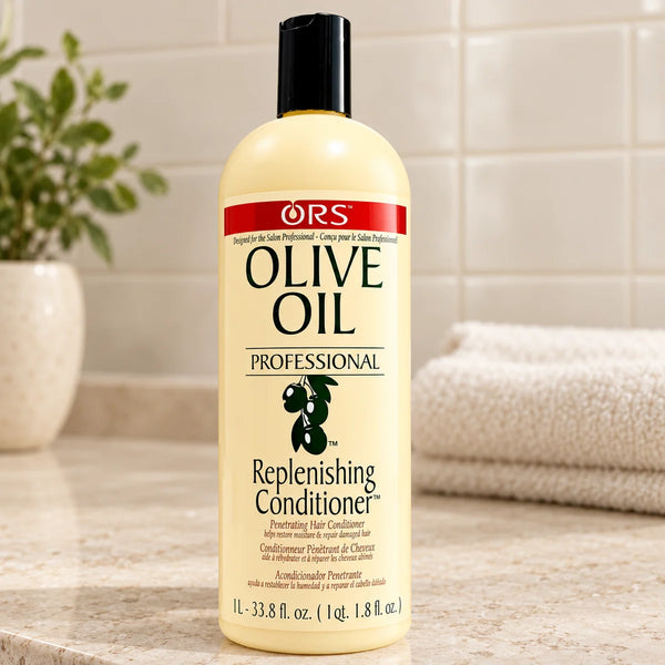 ORS Olive Oil Replenishing Conditioner — 33.8 oz on a bathroom vanity.