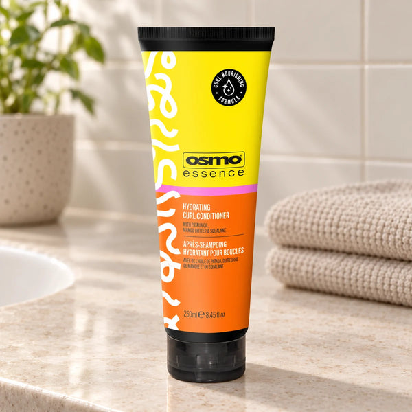 OSMO Essence Hydrating Curl Conditioner for Defined, Frizz-Free Curls — 250 ml on a bathroom vanity.