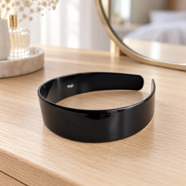 Reverie Hair Serenity Headbands — Black headband on a dressing table.