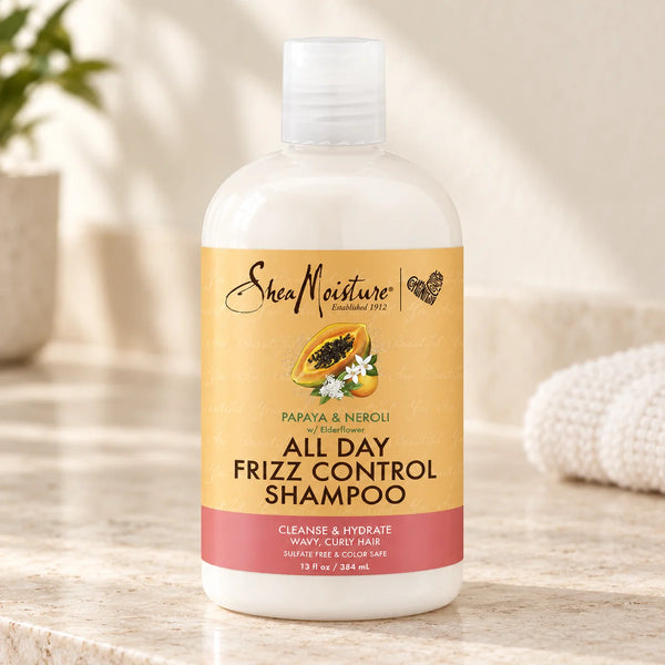 Shea Moisture Papaya & Neroli All-Day Frizz Control Shampoo — 13 oz on a bathroom vanity or dressing table.