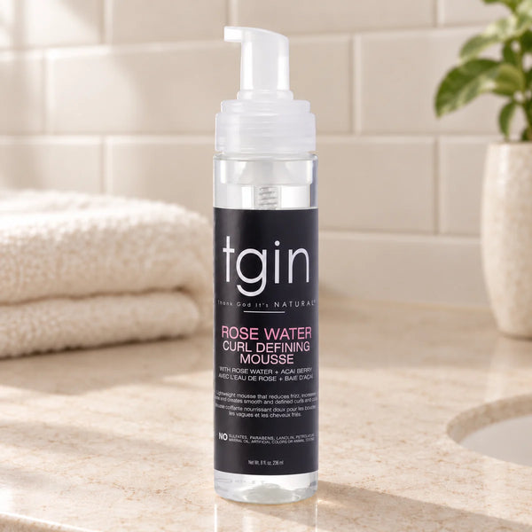TGIN Rose Water Curl Defining Mousse | Enhances & Defines Curls for Natural Hair | — 236 ml on a bathroom vanity.