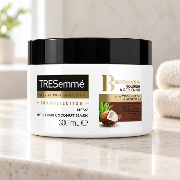 Tresemmé Hydrating Coconut Hair Mask: Deep Moisture for Dry Hair — 300 ml on a bathroom vanity or dressing table.