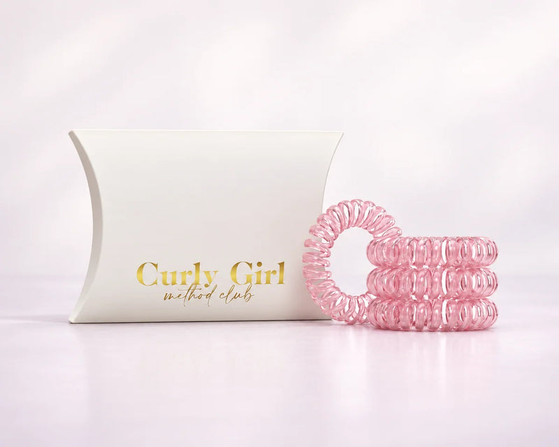 Set of four pink coiled hair bands with packaging