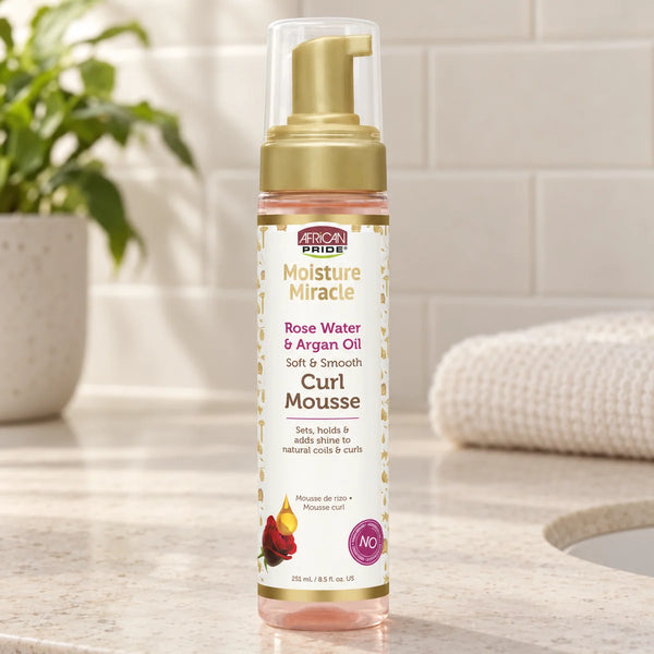 African Pride Moisture Miracle Curl Mousse — 251 ml on a bathroom vanity.