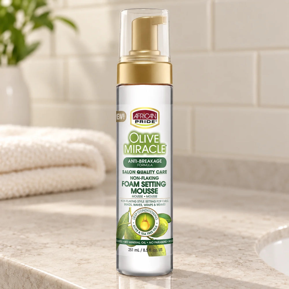 African Pride Olive Miracle Foam Setting Mousse — 8.5 oz on a bathroom vanity.