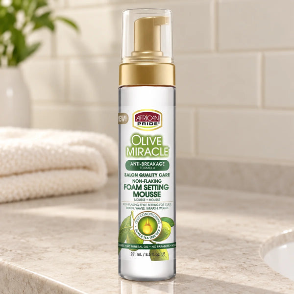 African Pride Olive Miracle Foam Setting Mousse — 8.5 oz on a bathroom vanity.