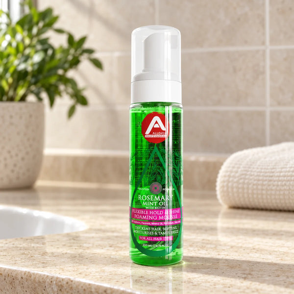 Allored Professional Rosemary Mint Oil & Biotin Foaming Mousse for All Hair Types — 200 ml on a bathroom vanity.