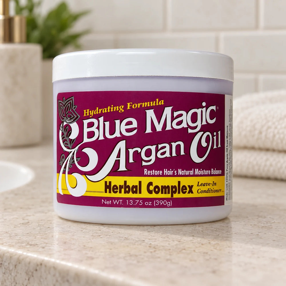Blue Magic Argan Oil Herbal Complex Leave-In Conditioner — 390 g on a bathroom vanity.