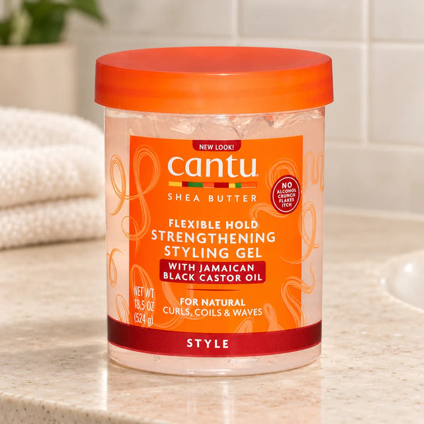 Cantu Strengthening Styling Gel with Jamaican Black Castor Oil for Defined Curls & Healthy Hair — 524 g on a bathroom vanity.