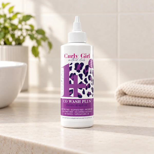 Co-Wash Plus+ 250ml bottle on a bathroom vanity.
