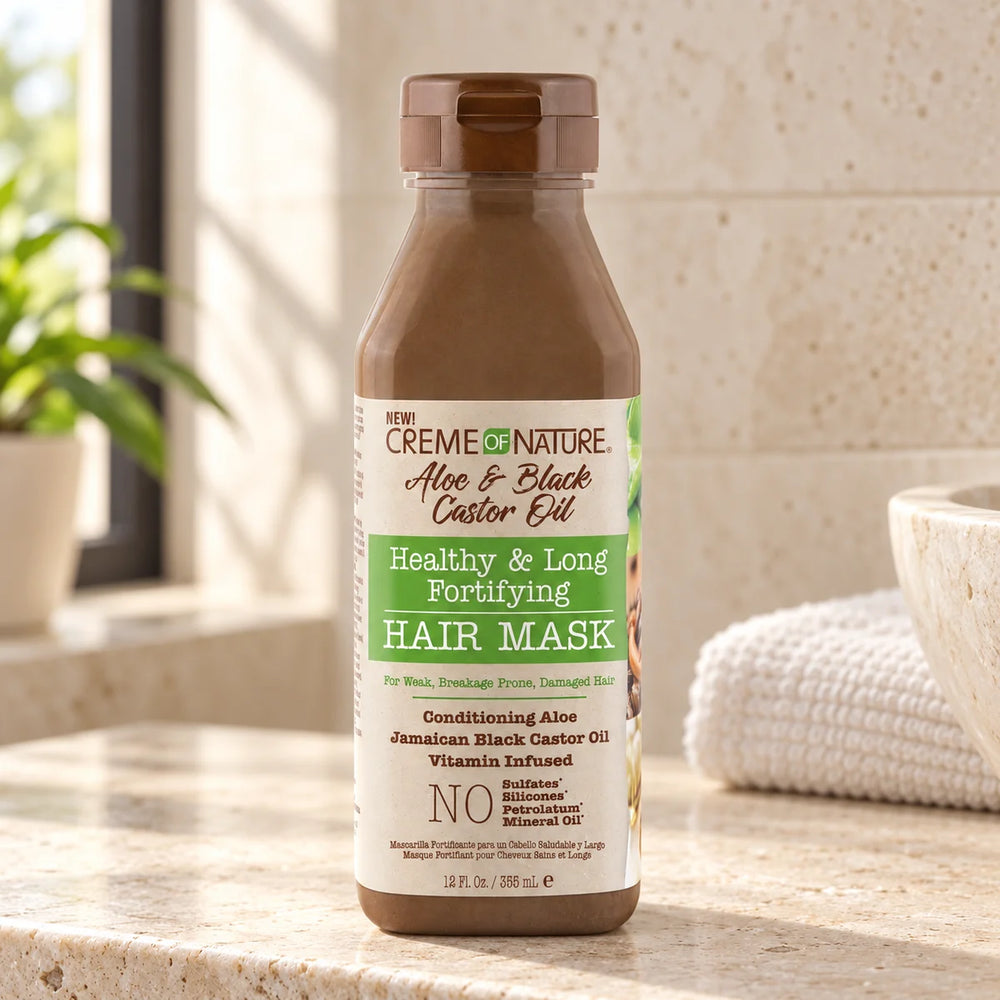Creme Of Nature Aloe & Black Castor Oil Healthy & Long Fortifying Hair Mask — 12 oz on a bathroom vanity or dressing table.