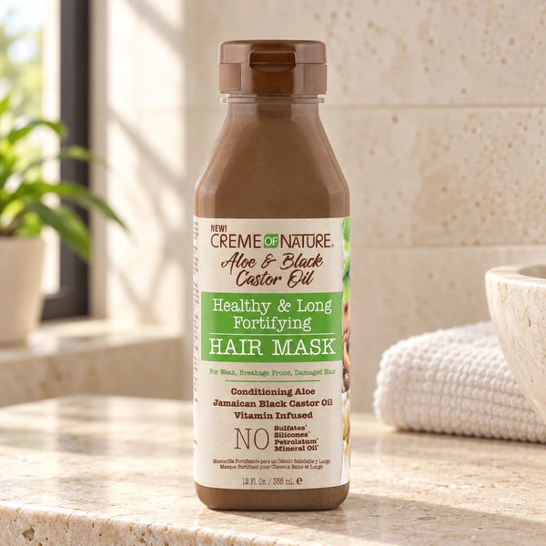 Creme Of Nature Aloe & Black Castor Oil Healthy & Long Fortifying Hair Mask — 12 oz on a bathroom vanity or dressing table.