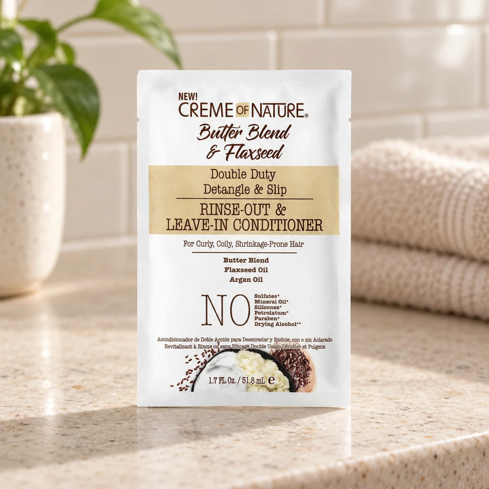 Creme of Nature Double Duty Detangle & Slip Rinse-Out & Leave-In Conditioner — 51.8 ml on a bathroom vanity.