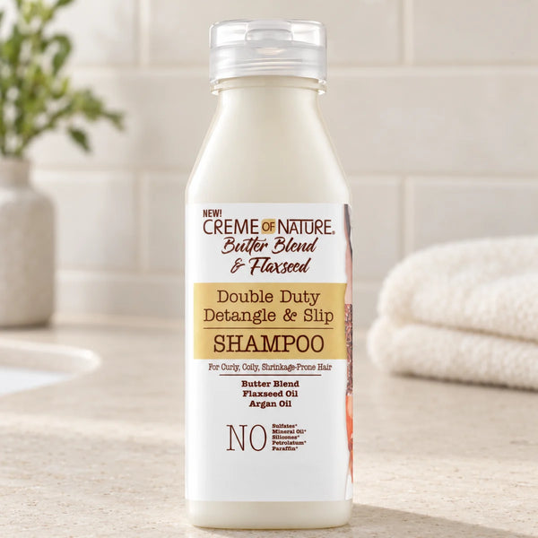 Creme of Nature Double Duty Detangle & Slip Shampoo — 12 oz on a bathroom vanity.