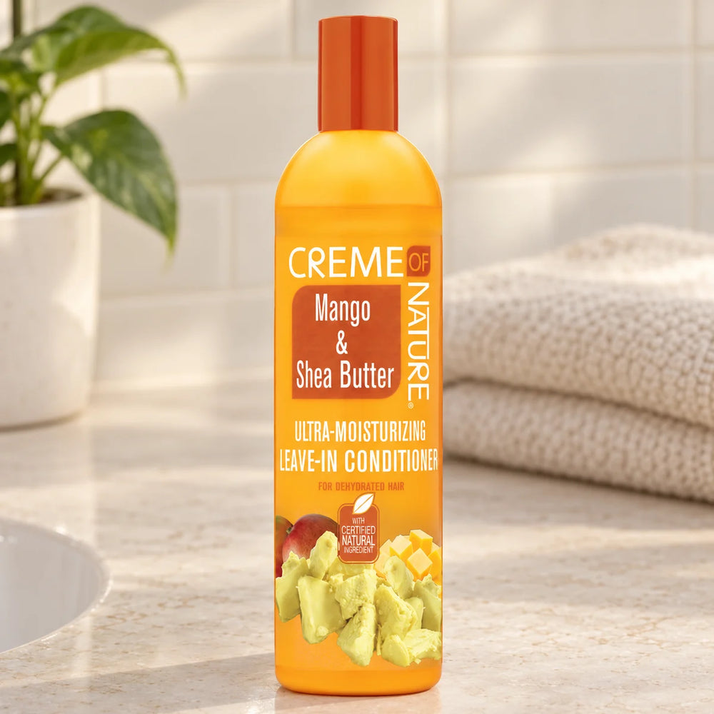 Creme Of Nature Mango & Shea Butter Leave-In Conditioner — 8.5 oz on a bathroom vanity.