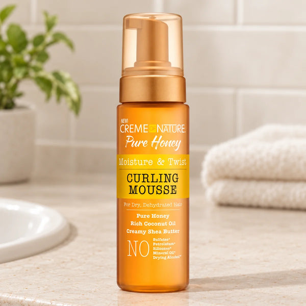 Creme of Nature Pure Honey Curling Mousse — 7 oz on a bathroom vanity.
