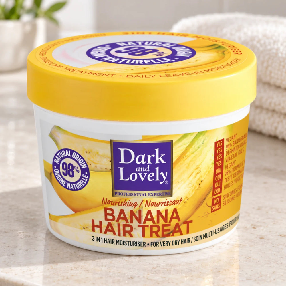 Dark & Lovely Banana Hair Treat 390 ml - 3-in-1 Nourishing Curly Hair Mask & Treatment — 390 ml on a bathroom vanity or dressing table.