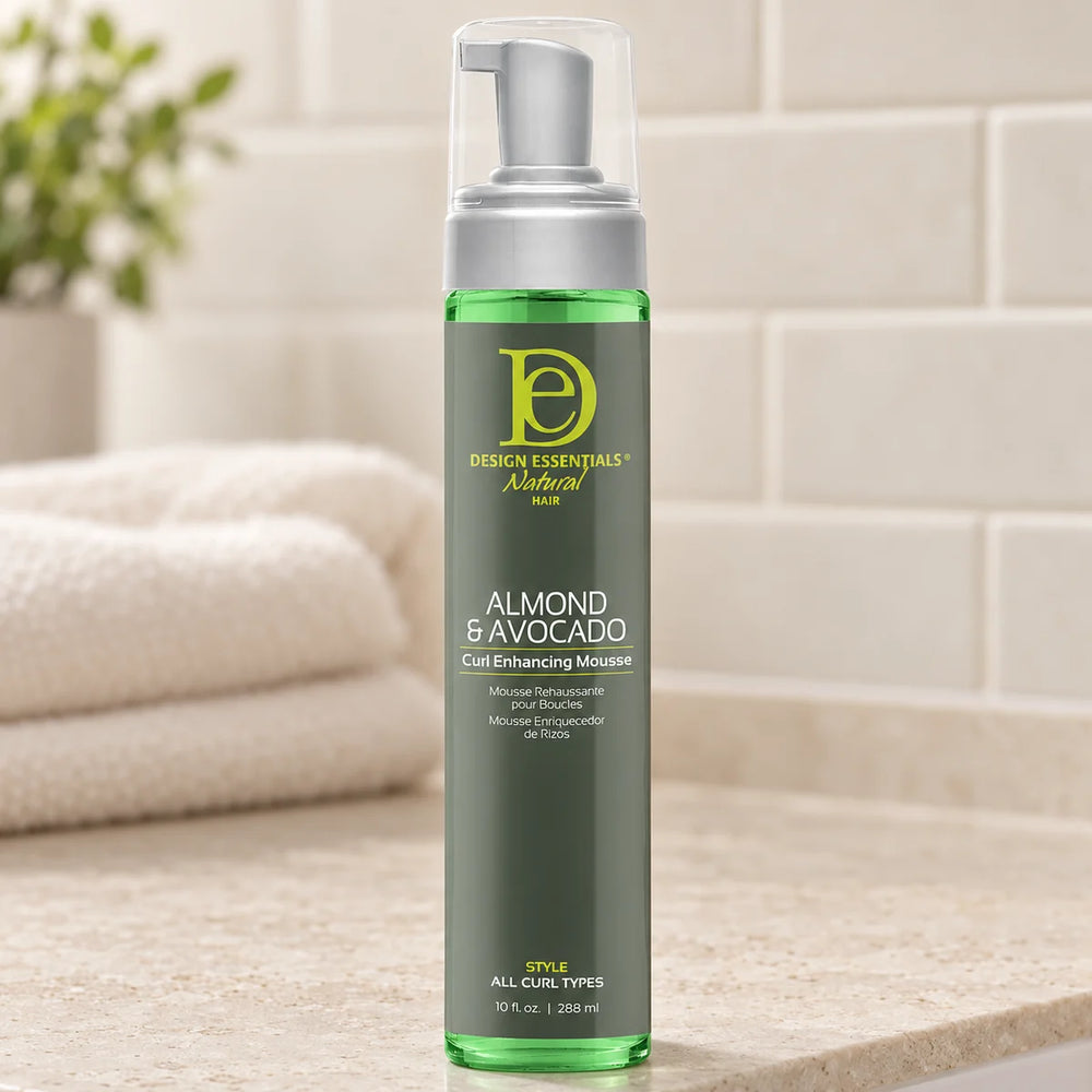 Design Essentials Almond & Avocado Curl Enhancing Mousse — 10 oz on a bathroom vanity.
