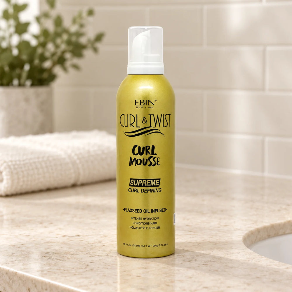 Ebin - Curl & Twist Curl Mousse Supreme Curl Defining Flaxseed Oil Infused - — 12 oz on a bathroom vanity.