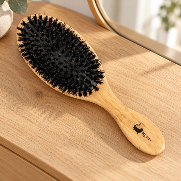 Eco Bath bamboo and boar-bristle hair brush on a wooden dressing table.
