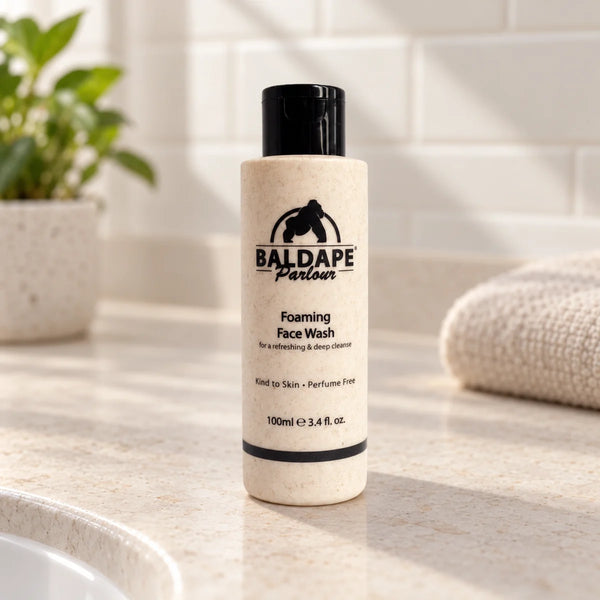 Baldape foaming beard and face wash bottle on a bathroom vanity.