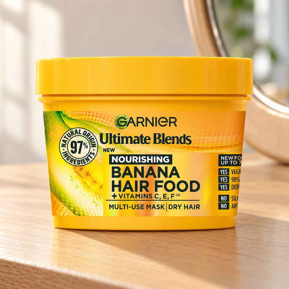 Garnier Banana Hair Food Nourishing & Restorative Multi-Use Mask for Dry, Damaged Hair — 390 ml on a bathroom vanity or dressing table.