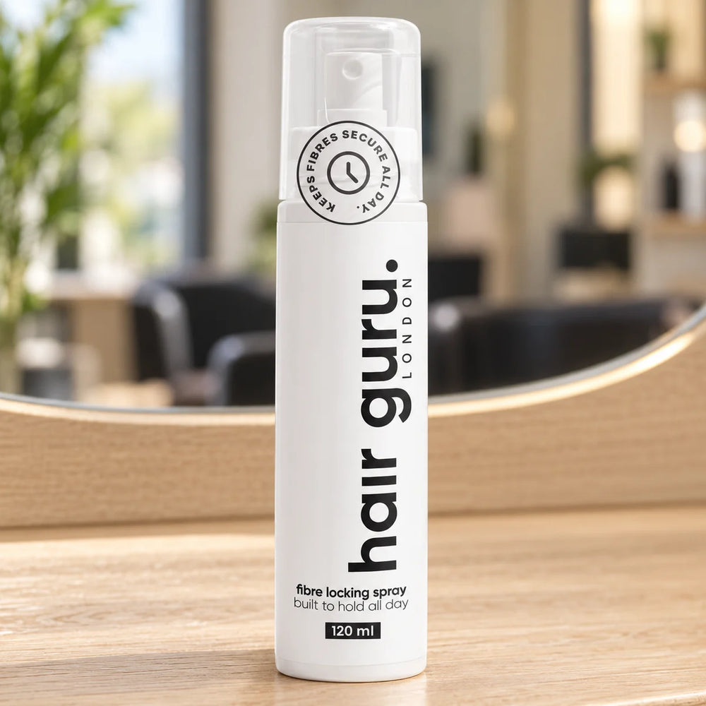 Hair Guru 120ml fibre locking spray bottle on a salon worktop.