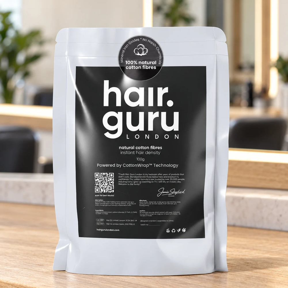 Hair Guru 100g refill pouch on a salon worktop.