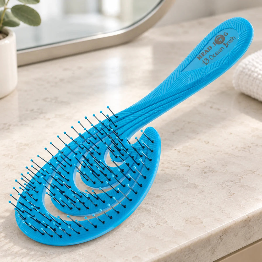 Head Jog 18 Ocean Brush — Aqua Head Jog 18 Ocean Brush on a bathroom vanity.