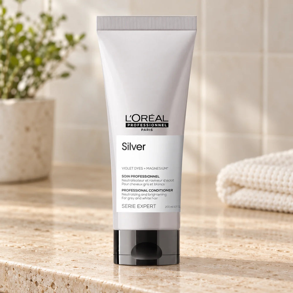 L'Oréal Professionnel Serié Expert Silver Conditioner Neutralising Brassy Tones & Enhancing Shine for Blonde & Silver Hair — 200 ml on a bathroom vanity.