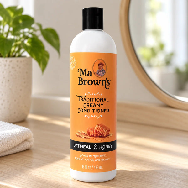 Ma Brown's Traditional Creamy Conditioner: Deeply Hydrating & Detangling for All Hair Types — 16 oz on a bathroom vanity.
