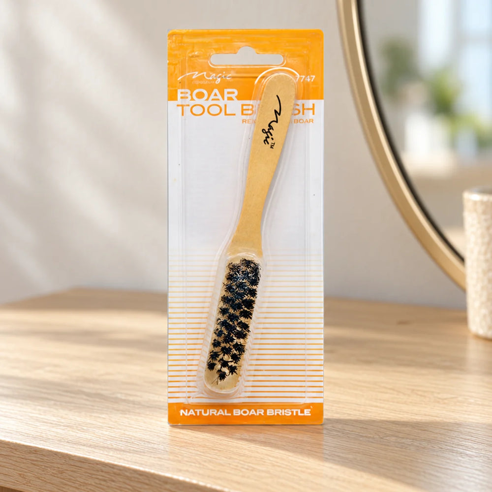 Magic Collection Boar Tool Brush (No.7747) Effortless Styling & Edge Control for Hair Professionals & Enthusiasts on a bathroom vanity or dressing table.
